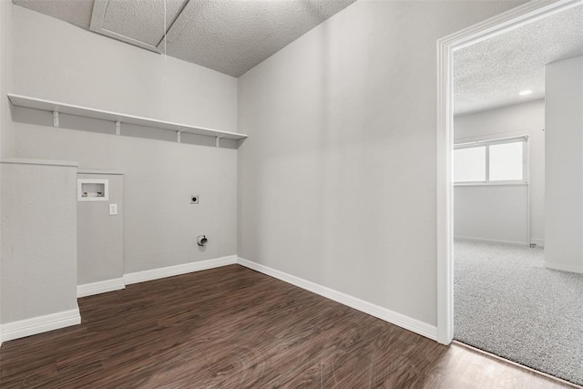 washroom featuring a textured ceiling, washer hookup, dark hardwood / wood-style floors, and hookup for an electric dryer