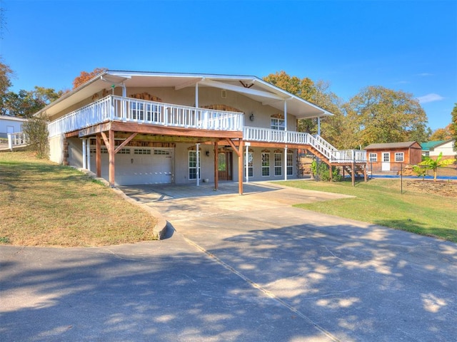 view of front of home with a front yard, a garage, and a deck