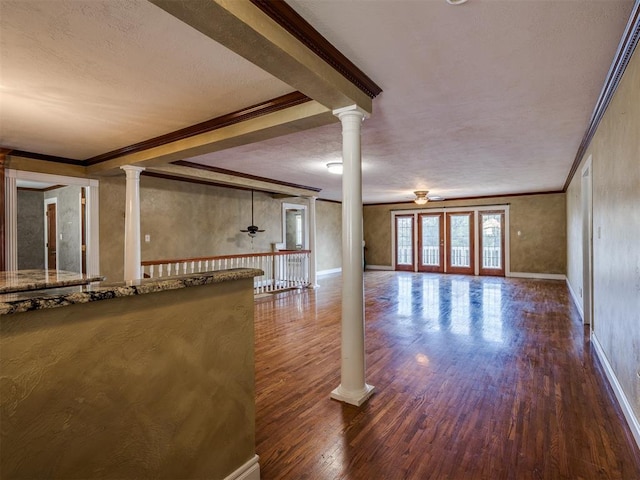 interior space with french doors, a textured ceiling, hardwood / wood-style flooring, and crown molding