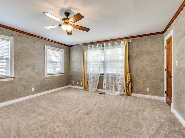 spare room with light colored carpet, ceiling fan, and crown molding