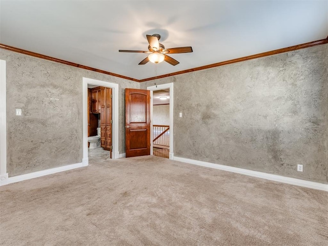 interior space featuring carpet flooring, ceiling fan, crown molding, and ensuite bath