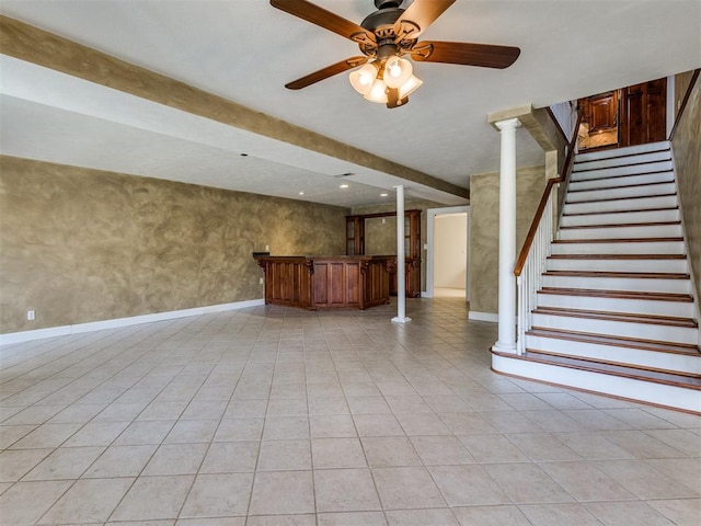 unfurnished living room featuring ceiling fan, light tile patterned floors, and decorative columns