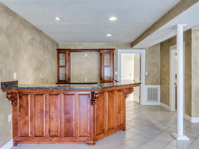 kitchen with ornate columns and light tile patterned flooring