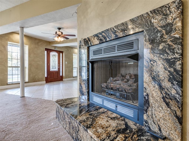 room details with ceiling fan and a textured ceiling