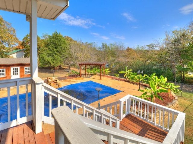 view of swimming pool featuring a pergola and a deck