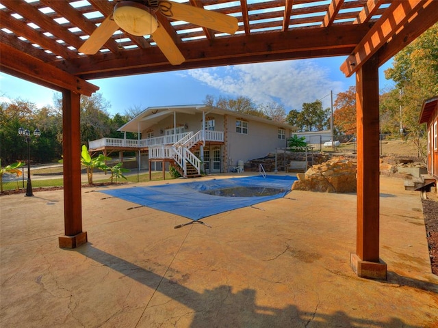 view of pool with a pergola, ceiling fan, and a patio area