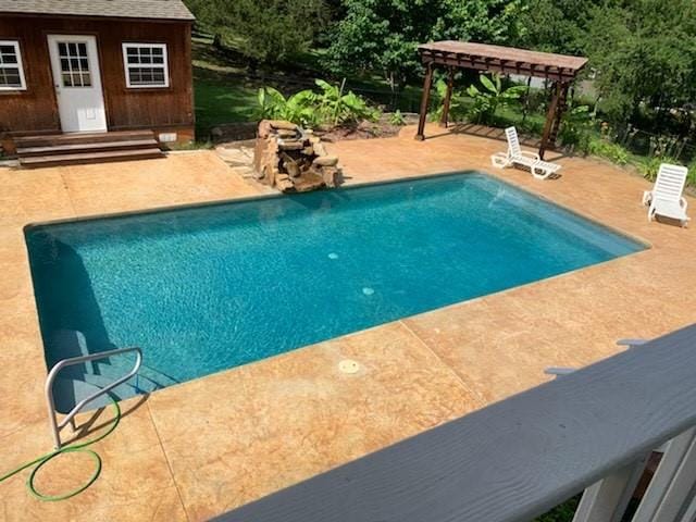 view of pool featuring a patio area and an outdoor structure