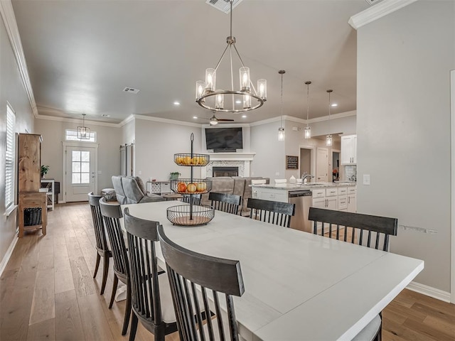 dining room featuring a chandelier, wood-type flooring, and ornamental molding