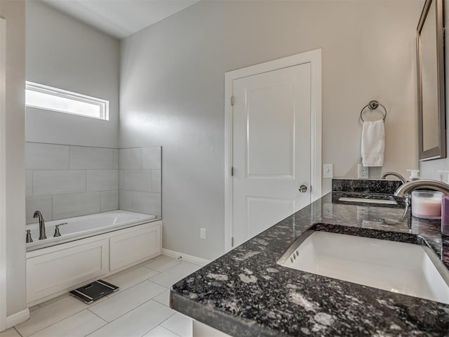 bathroom featuring tile patterned floors, vanity, and a tub to relax in