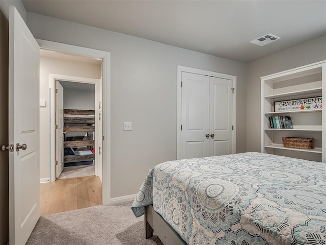 bedroom featuring light hardwood / wood-style floors and a closet