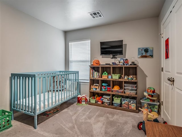 bedroom featuring carpet flooring and a crib