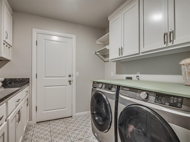 laundry area featuring cabinets, light tile patterned flooring, and washer and dryer