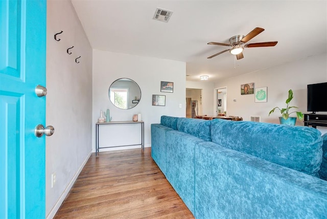 living room featuring light hardwood / wood-style floors and ceiling fan