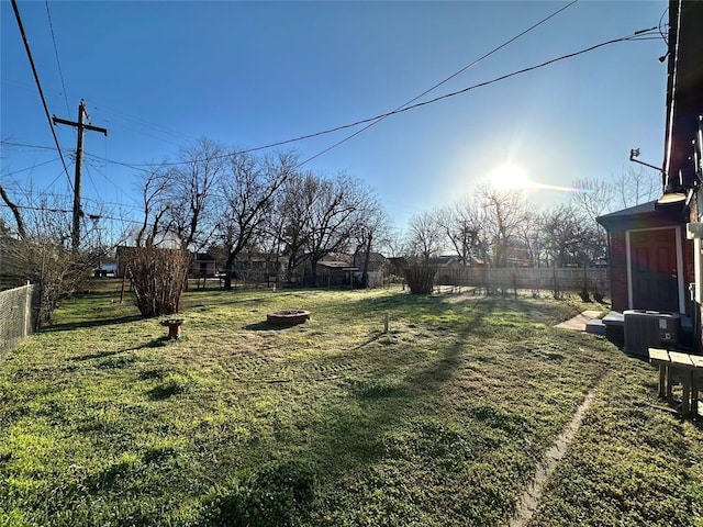 view of yard with an outdoor fire pit and a fenced backyard