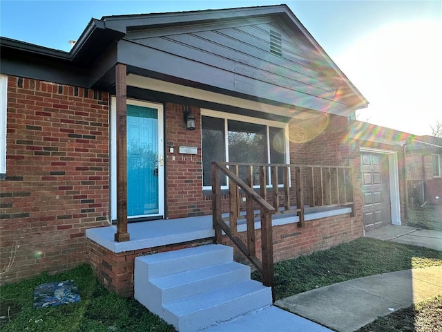 view of front facade with brick siding and a garage