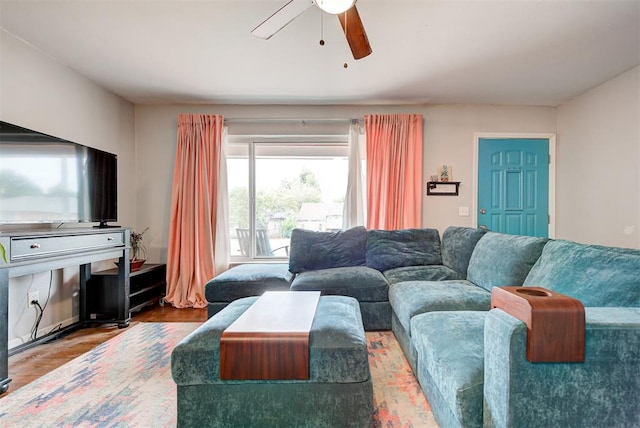 living area with a ceiling fan and wood finished floors