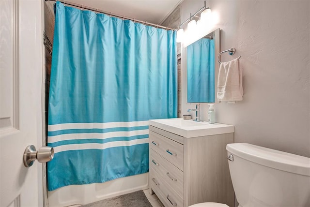 bathroom with shower / tub combo, toilet, and vanity