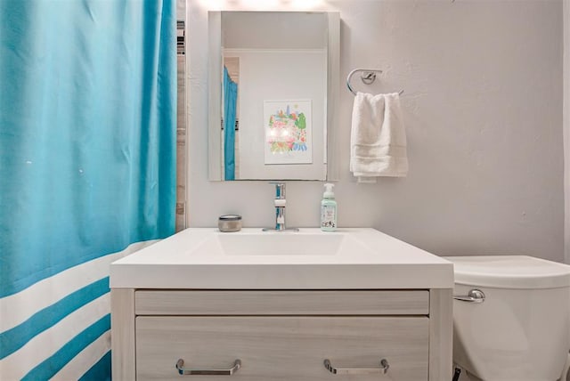 bathroom with toilet and vanity