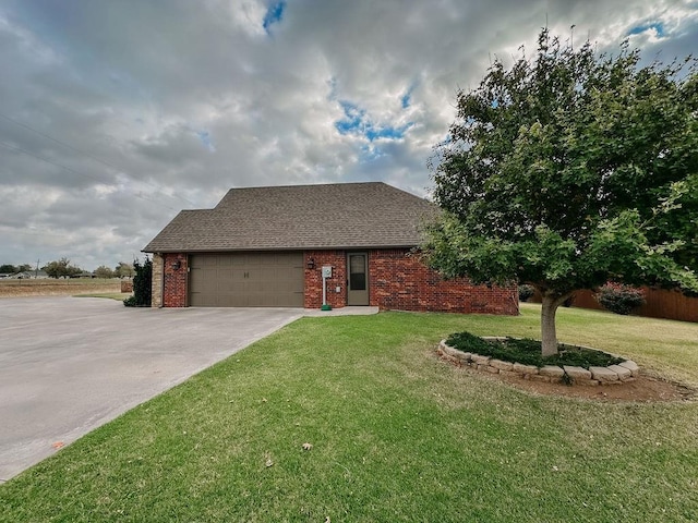 view of front of home with a front yard and a garage