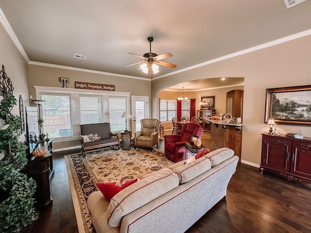 living room featuring ceiling fan with notable chandelier, dark hardwood / wood-style floors, and ornamental molding