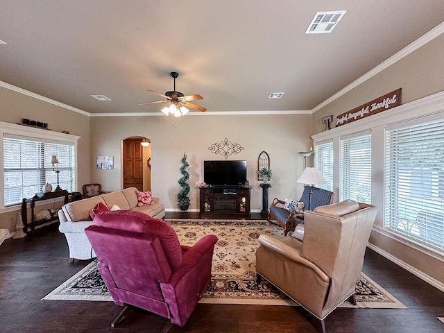 living room featuring dark hardwood / wood-style flooring, crown molding, and a healthy amount of sunlight