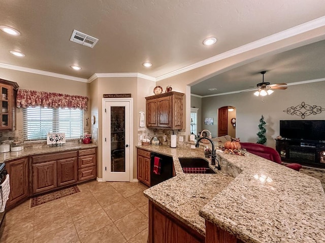 kitchen featuring tasteful backsplash, crown molding, sink, and black appliances