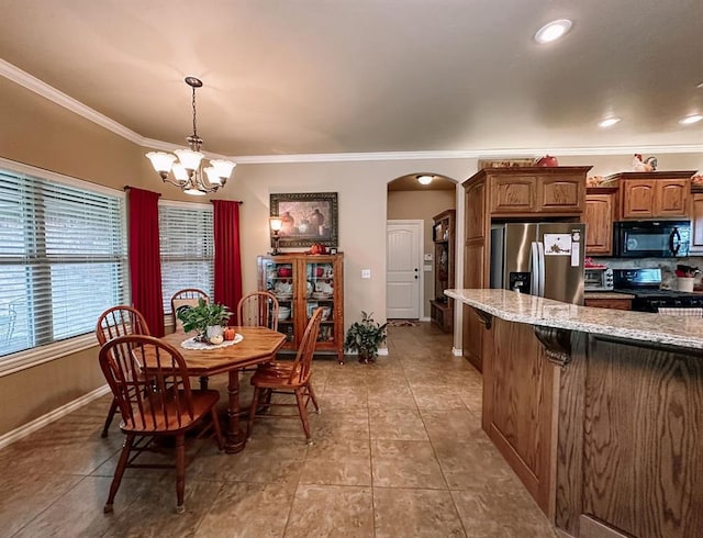 dining area featuring light tile patterned floors, crown molding, and a chandelier