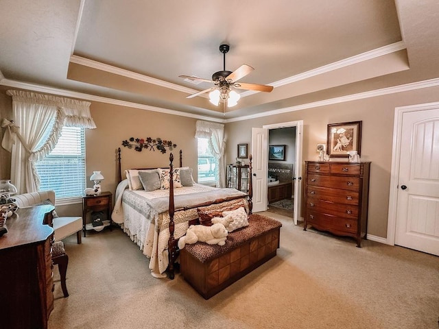 bedroom with a raised ceiling, multiple windows, and ceiling fan