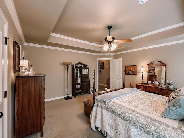 bedroom featuring a tray ceiling, ceiling fan, light colored carpet, and ornamental molding