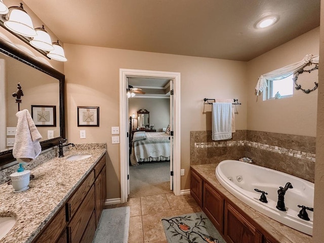 bathroom with a tub, tile patterned flooring, and vanity