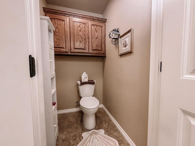 bathroom featuring toilet and tile patterned floors