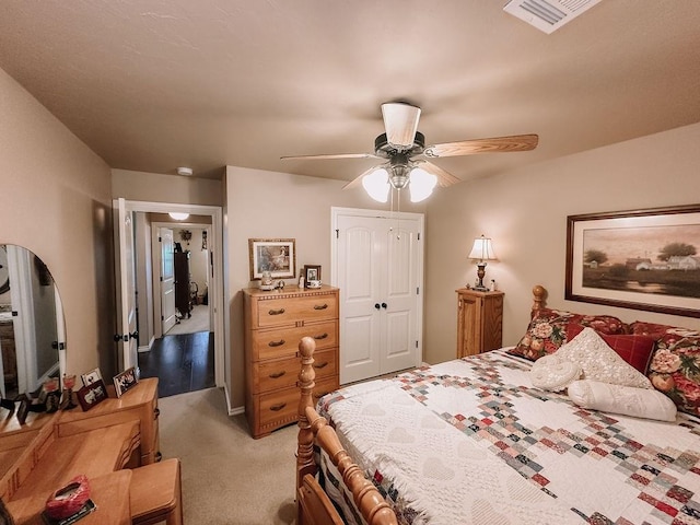 bedroom featuring ceiling fan, light carpet, and a closet