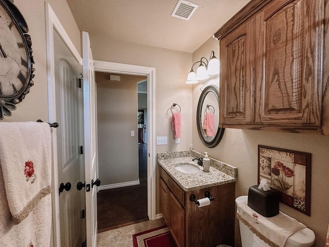 bathroom featuring vanity and toilet