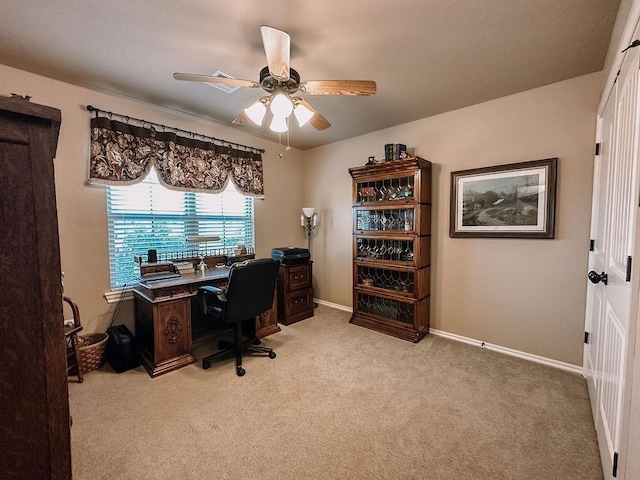 home office with ceiling fan and light carpet