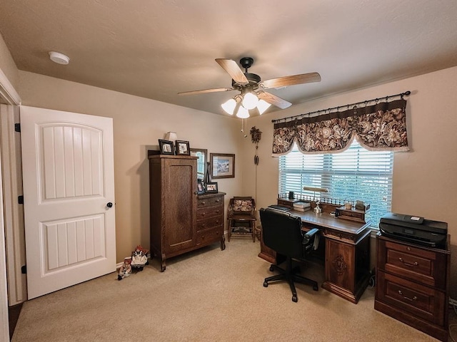 office area featuring light carpet and ceiling fan