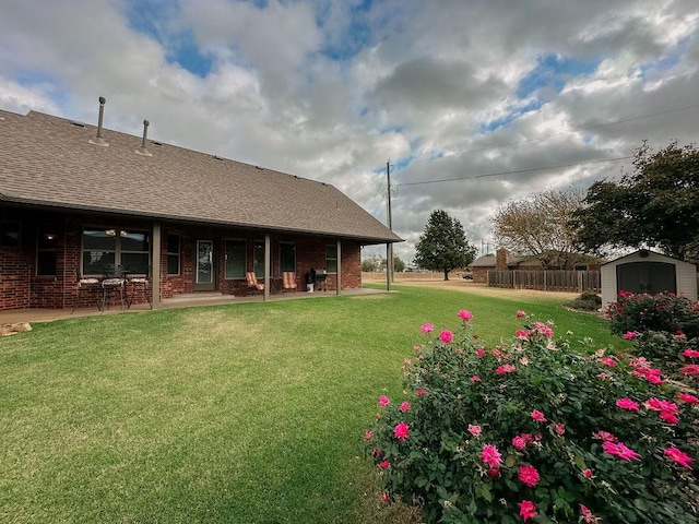 view of yard featuring a patio and a storage shed