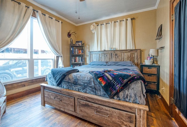 bedroom featuring ceiling fan, crown molding, and dark wood-type flooring