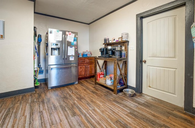 kitchen with stainless steel fridge with ice dispenser, dark hardwood / wood-style floors, and ornamental molding