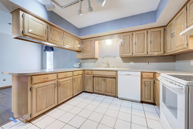 kitchen featuring kitchen peninsula, white appliances, and sink