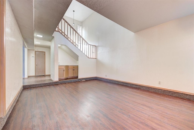 interior space featuring a chandelier, hardwood / wood-style floors, and a towering ceiling