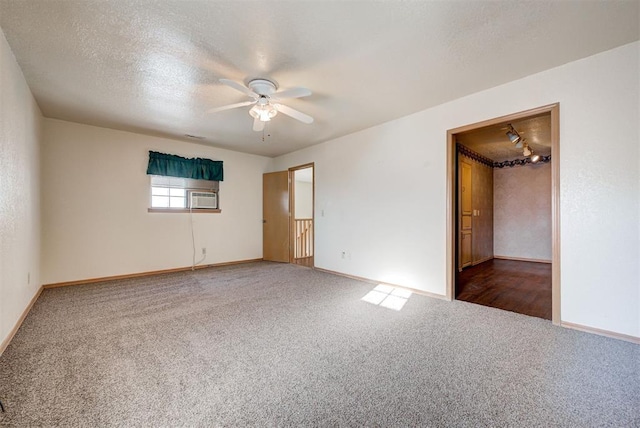 unfurnished bedroom featuring ceiling fan, carpet, and a textured ceiling