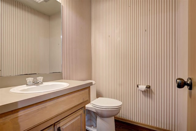 bathroom featuring hardwood / wood-style floors, vanity, and toilet