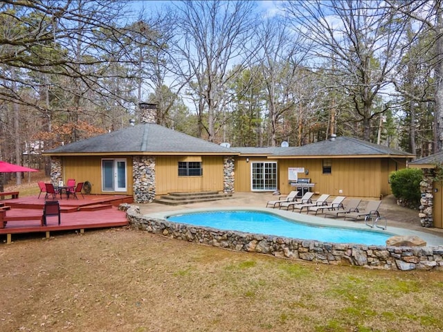 view of pool with a patio and a deck