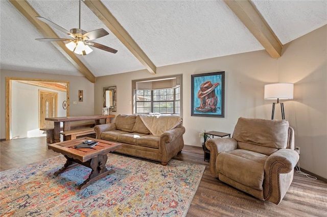 living room featuring vaulted ceiling with beams, ceiling fan, dark hardwood / wood-style flooring, and a textured ceiling