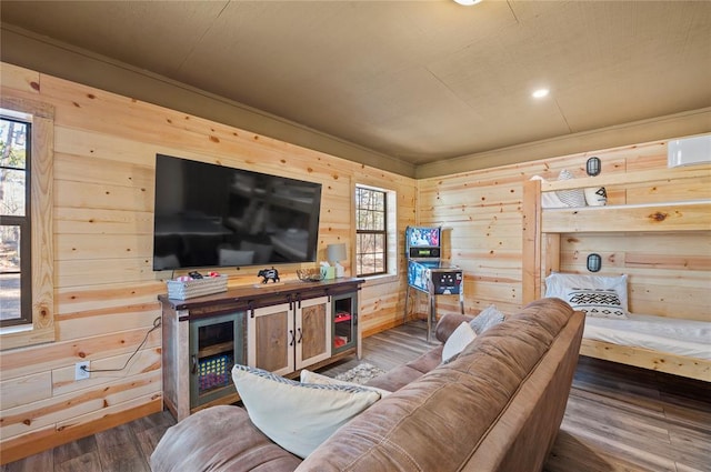 living room featuring dark hardwood / wood-style floors and wooden walls