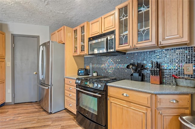 kitchen featuring appliances with stainless steel finishes, backsplash, light hardwood / wood-style floors, and light brown cabinetry