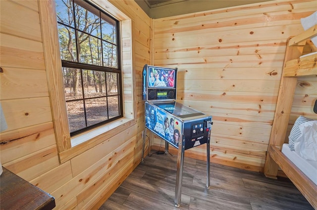 interior space with hardwood / wood-style flooring and wood walls