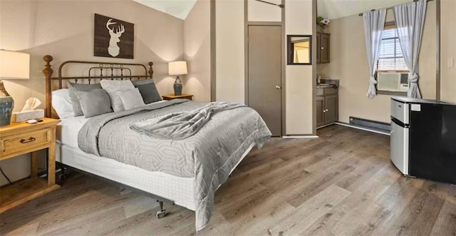 bedroom with wood-type flooring, vaulted ceiling, stainless steel refrigerator, and cooling unit