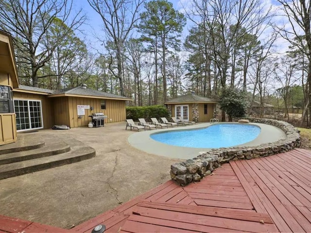 view of pool featuring an outbuilding, area for grilling, and a patio area