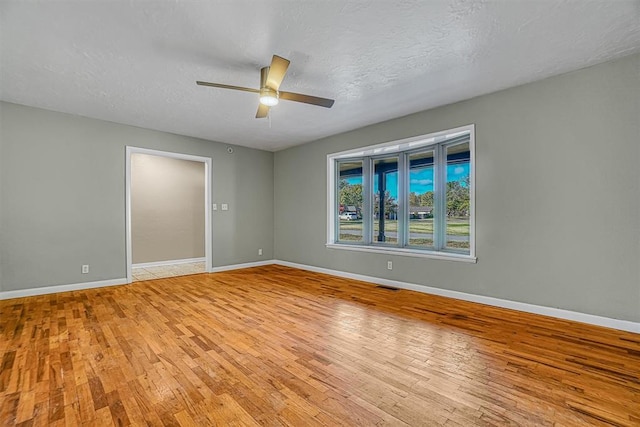 spare room featuring light wood-style flooring and baseboards